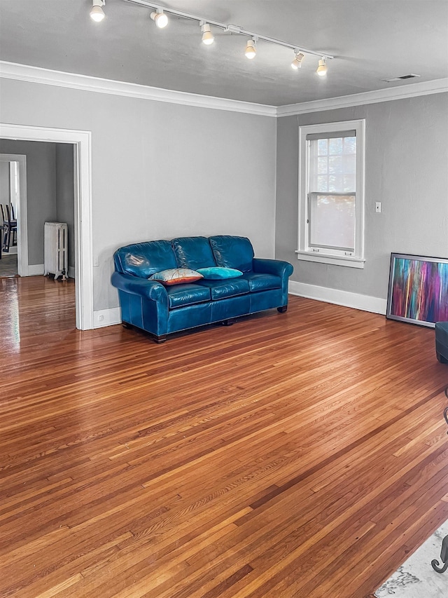 living area featuring radiator heating unit and ornamental molding