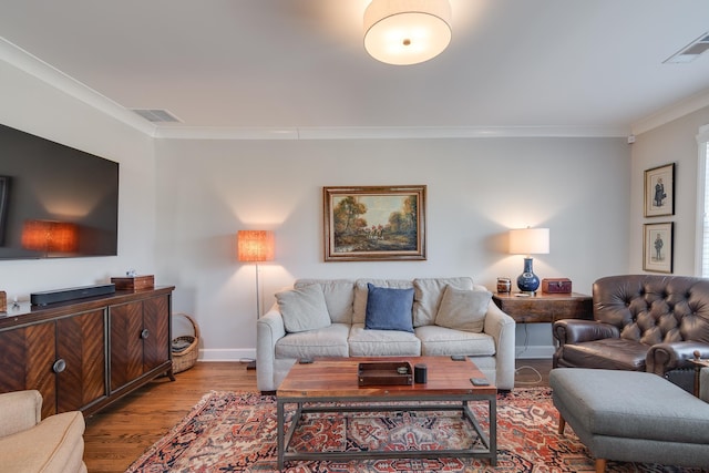 living room with light hardwood / wood-style floors and crown molding