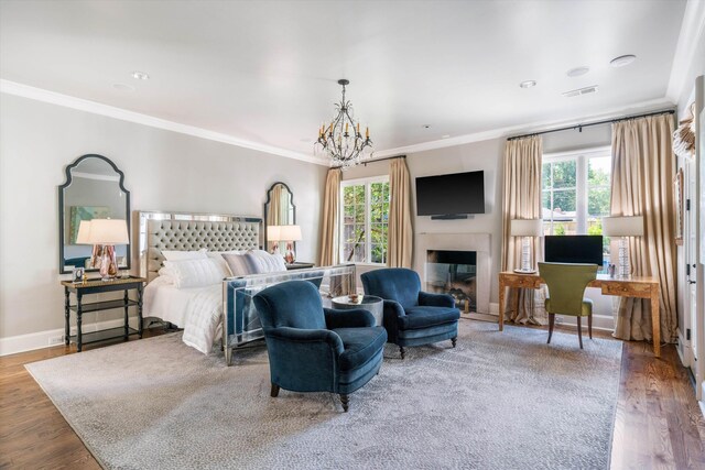 bedroom featuring wood-type flooring, ornamental molding, and an inviting chandelier