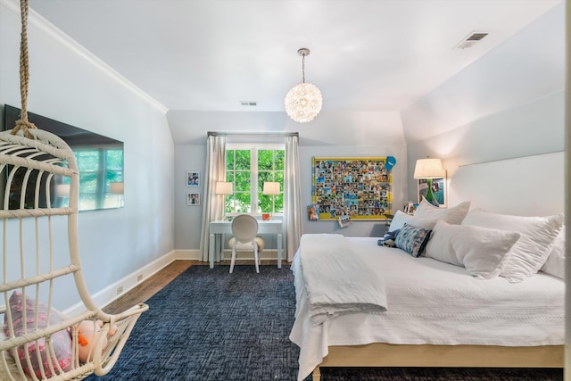 bedroom with dark hardwood / wood-style flooring, lofted ceiling, ornamental molding, and an inviting chandelier