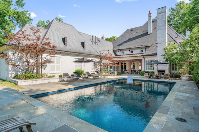 exterior space with a patio area and an outdoor fireplace