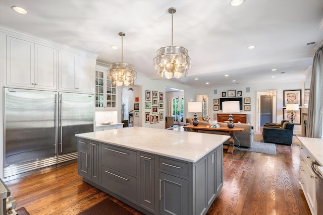 kitchen featuring white cabinets, decorative light fixtures, stainless steel built in fridge, and gray cabinetry