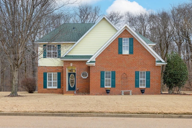 view of property featuring a front lawn