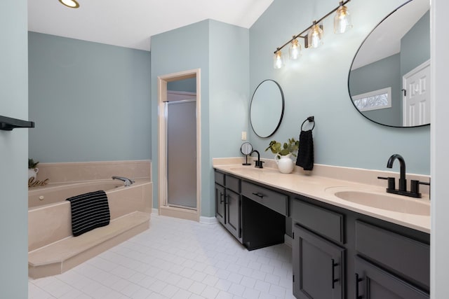 bathroom featuring tile patterned flooring, vanity, and shower with separate bathtub