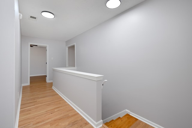 corridor with light hardwood / wood-style floors