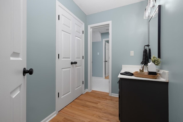 bathroom with vanity, a textured ceiling, and hardwood / wood-style flooring