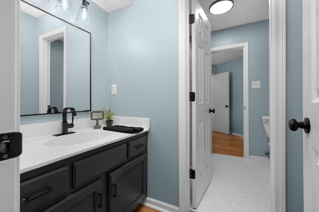 bathroom with tile patterned flooring, vanity, and toilet