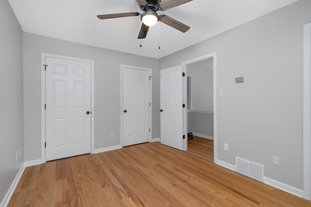 unfurnished bedroom with ceiling fan and light wood-type flooring