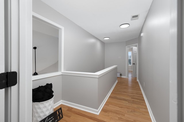 corridor with hardwood / wood-style floors