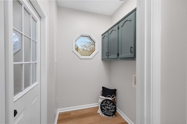 laundry room featuring cabinets, hookup for a washing machine, and light hardwood / wood-style flooring