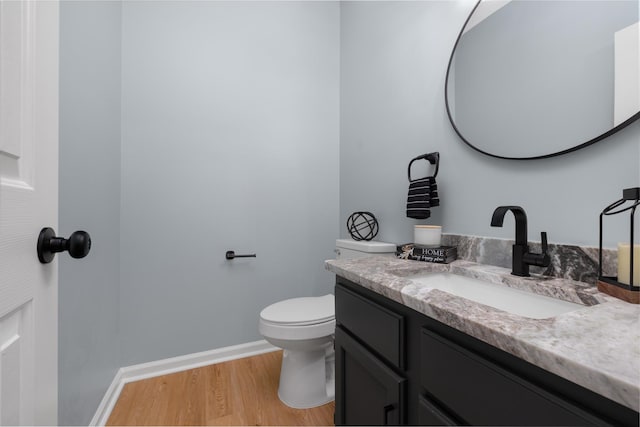 bathroom featuring hardwood / wood-style floors, vanity, and toilet