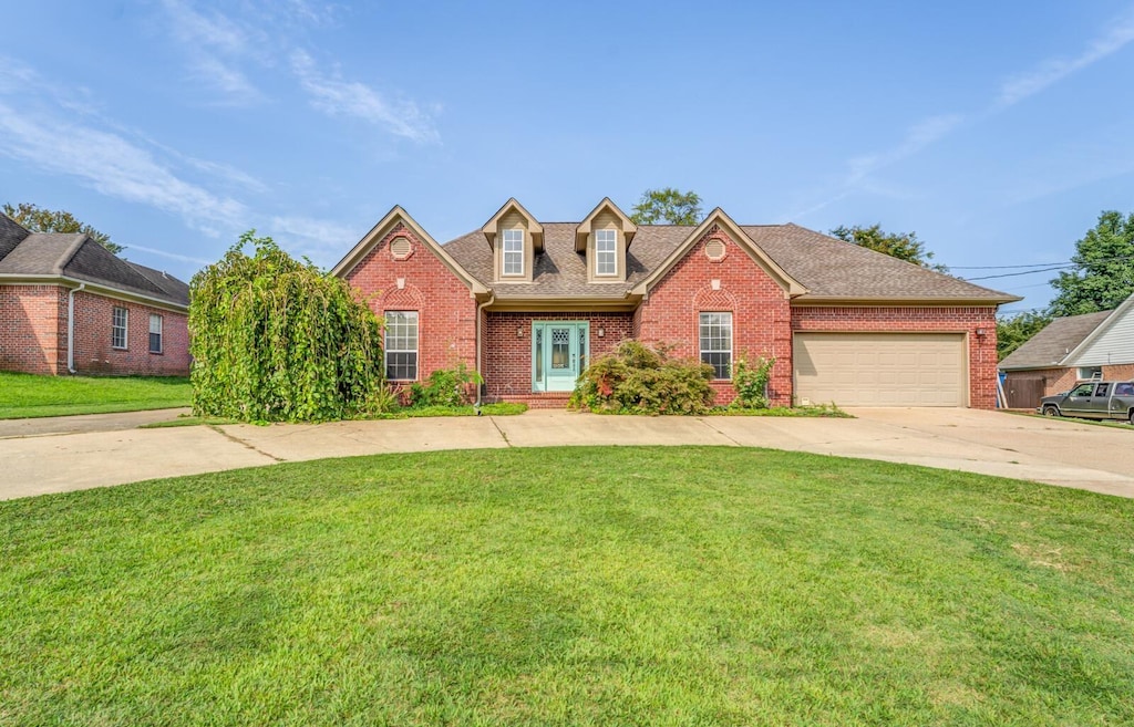 view of front of house with a front lawn and a garage