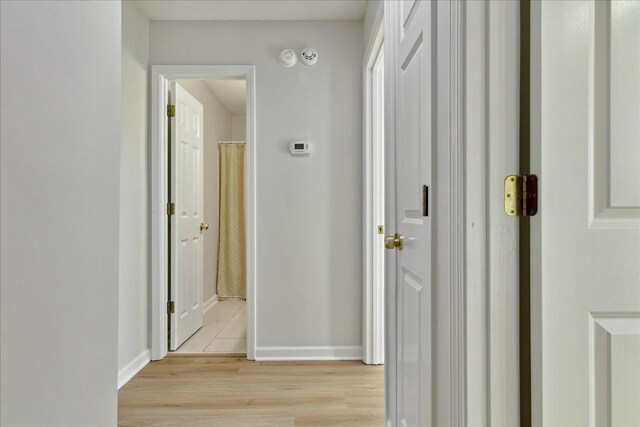 hall with light hardwood / wood-style floors