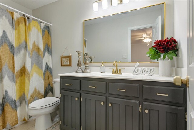 bathroom with tile patterned floors, vanity, a shower with shower curtain, and toilet