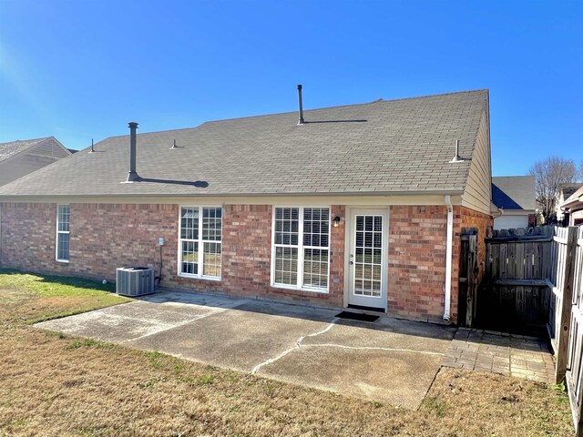 rear view of property featuring central AC unit and a patio area