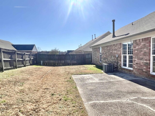 view of yard featuring central AC unit and a patio area