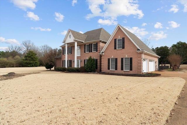 view of front of house featuring brick siding and driveway