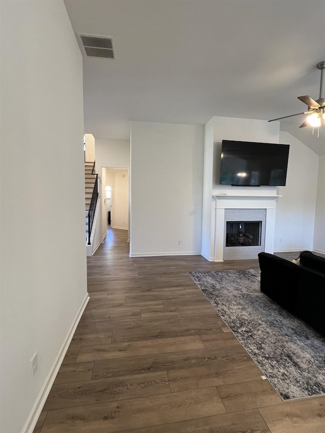 unfurnished living room with dark hardwood / wood-style floors and ceiling fan