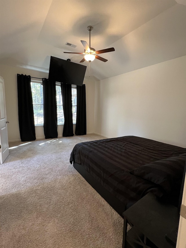 bedroom with ceiling fan, light carpet, and vaulted ceiling