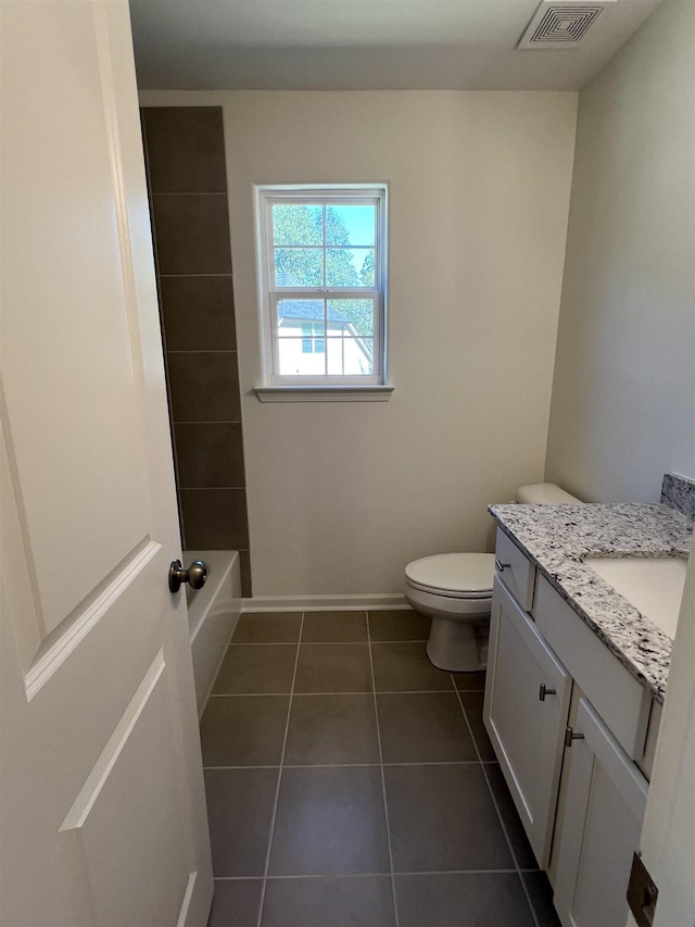 bathroom with tile patterned flooring, vanity, and toilet