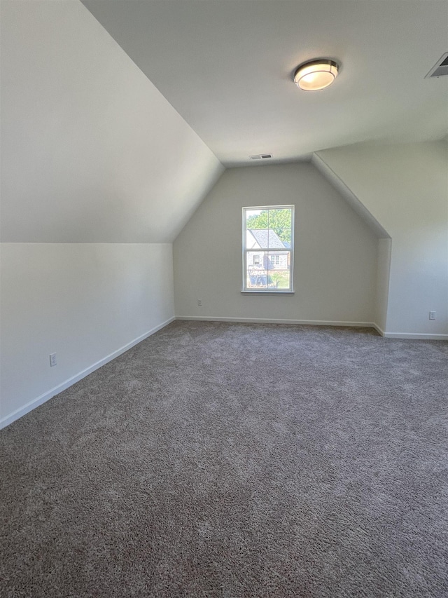 bonus room with carpet and lofted ceiling