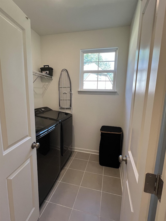 laundry room with separate washer and dryer and tile patterned flooring