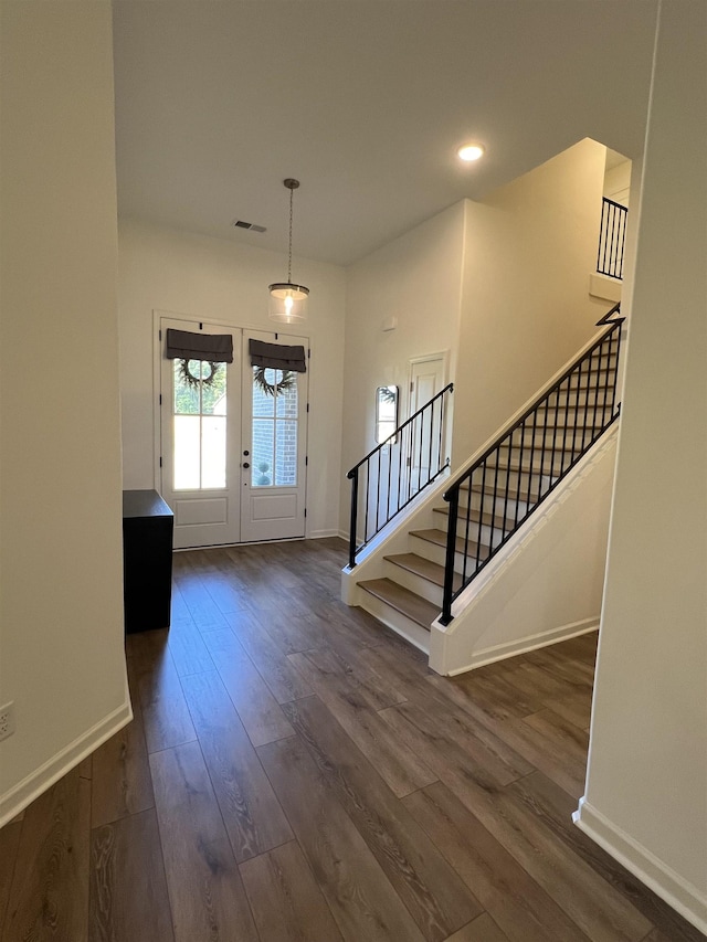 foyer featuring dark hardwood / wood-style flooring and french doors