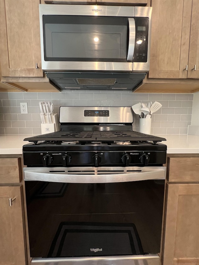 kitchen featuring decorative backsplash, light brown cabinetry, and appliances with stainless steel finishes