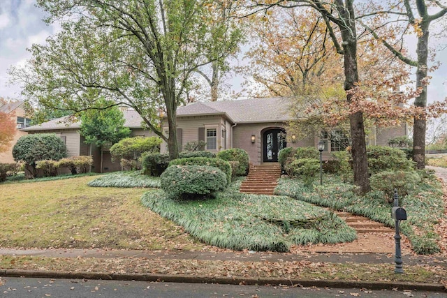 single story home featuring a front lawn