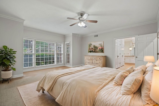 bedroom with light hardwood / wood-style flooring, ensuite bath, ceiling fan, and crown molding