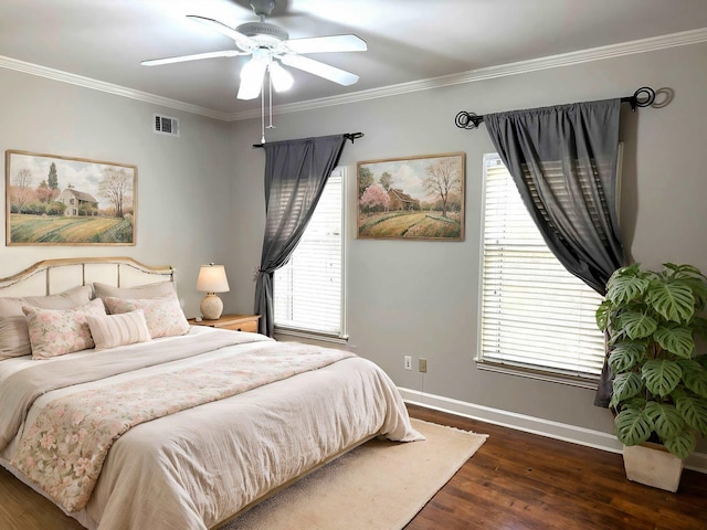 bedroom with ceiling fan, dark wood-type flooring, and ornamental molding