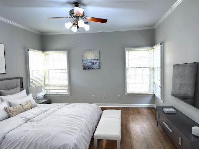 bedroom with dark hardwood / wood-style flooring, ceiling fan, and crown molding