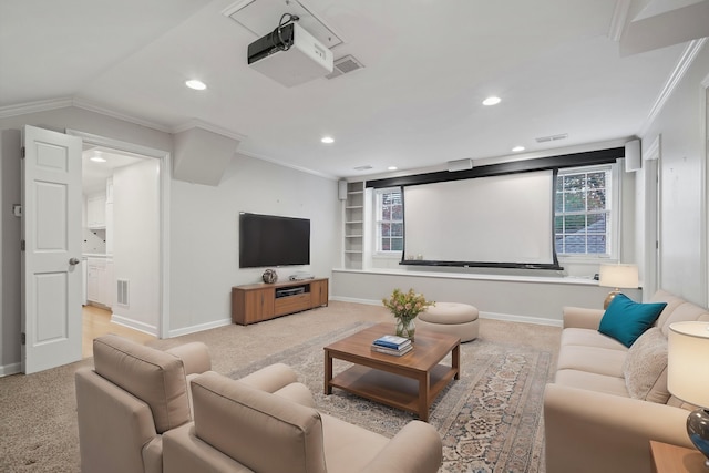 carpeted home theater room with built in shelves, crown molding, and vaulted ceiling