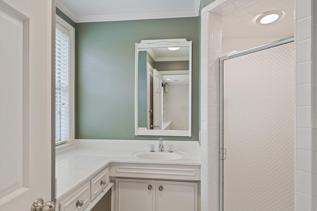 bathroom featuring vanity, ornamental molding, a shower with door, and a wealth of natural light