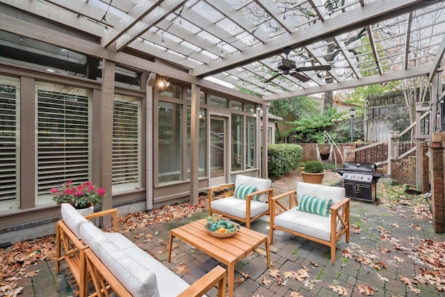 view of patio featuring a pergola, a grill, an outdoor living space, and ceiling fan