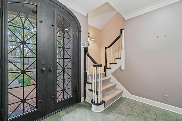 foyer entrance featuring crown molding and french doors