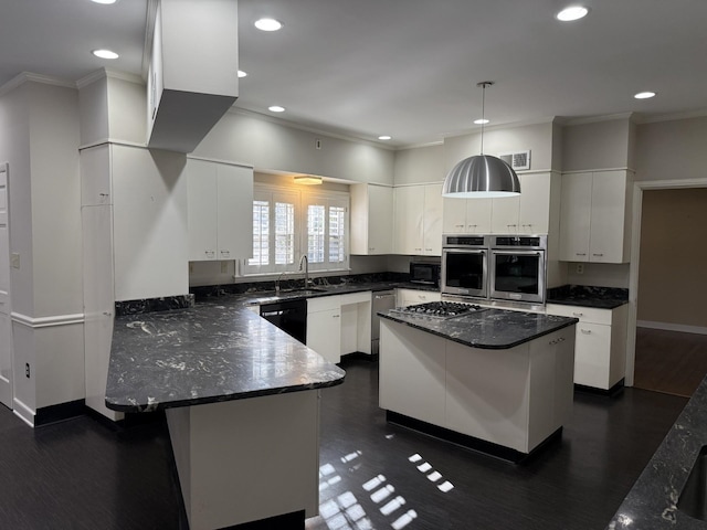 kitchen with a breakfast bar, a center island, white cabinets, and decorative light fixtures