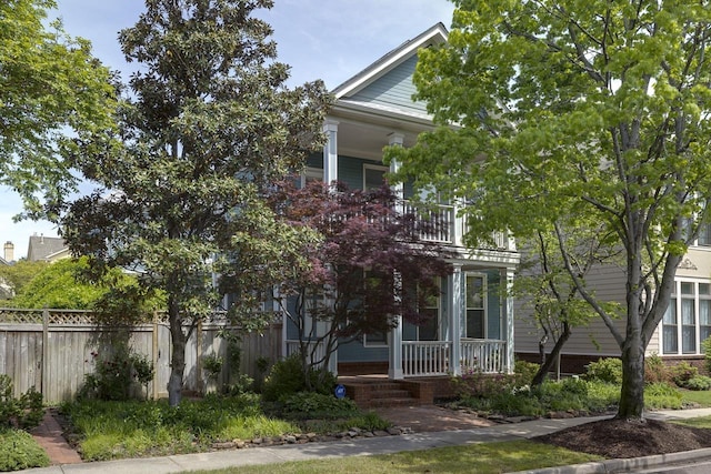 view of front of property featuring a porch and a balcony