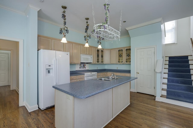 kitchen with light brown cabinets, white appliances, an inviting chandelier, a center island with sink, and sink