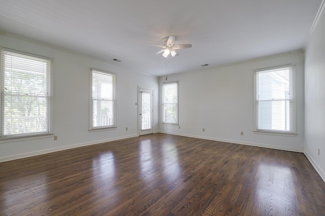 empty room with ceiling fan, dark hardwood / wood-style flooring, and crown molding