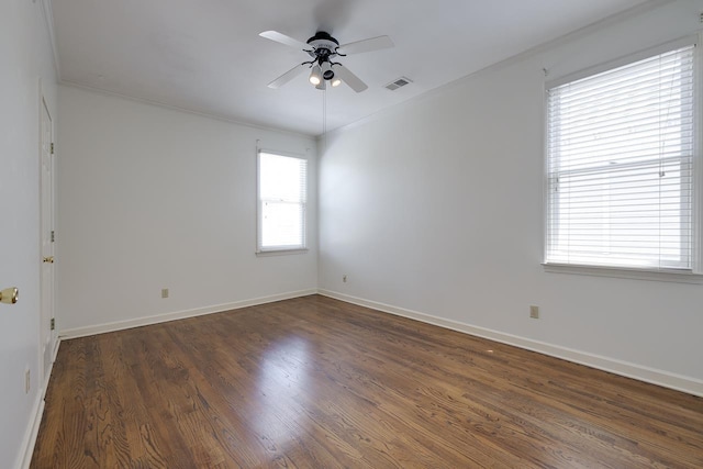 empty room with dark hardwood / wood-style flooring, ceiling fan, and crown molding