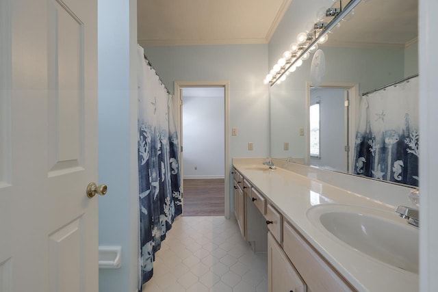 bathroom with tile patterned flooring, vanity, and crown molding