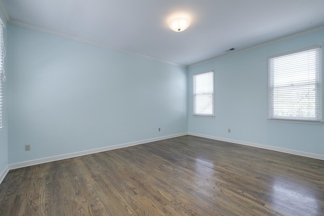 empty room with dark hardwood / wood-style floors and crown molding