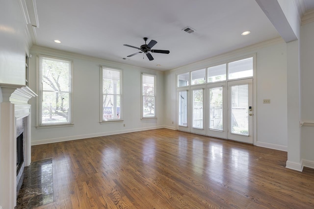 unfurnished living room with crown molding, ceiling fan, and dark wood-type flooring