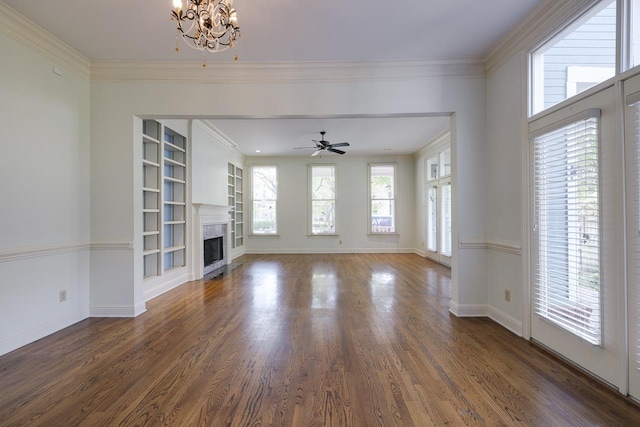 unfurnished living room with a wealth of natural light, built in features, and crown molding