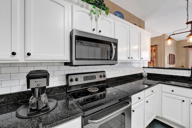 kitchen with hanging light fixtures, sink, decorative backsplash, appliances with stainless steel finishes, and white cabinetry