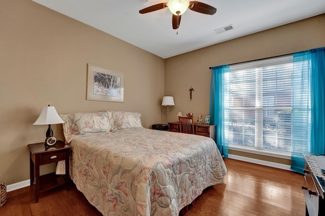 bedroom with hardwood / wood-style floors and ceiling fan