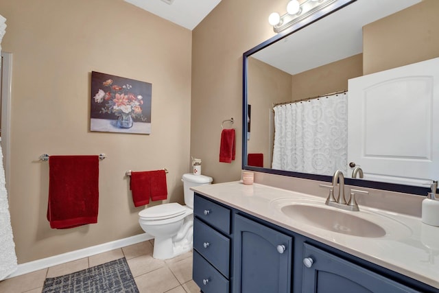 bathroom with toilet, vanity, and tile patterned floors