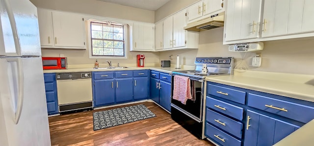 kitchen with dark hardwood / wood-style flooring, white appliances, blue cabinets, sink, and white cabinets