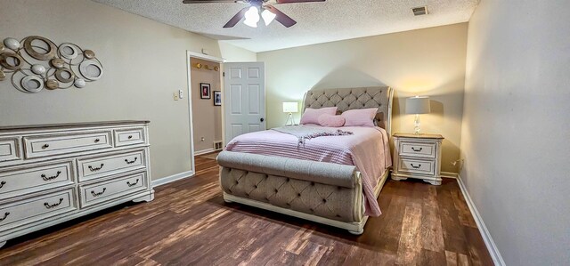 bedroom with ceiling fan, dark hardwood / wood-style flooring, and a textured ceiling